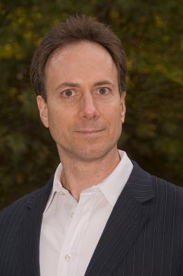 A man in a suit and tie standing outside.