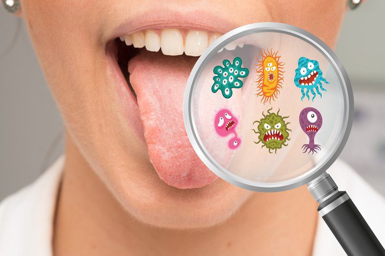 A person with their tongue hanging out looking at the bacteria on her mouth.