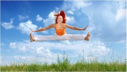 A woman is doing an air trick in the sky.