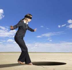 A woman standing on the ground near a hole.