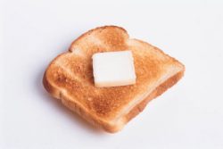 A piece of toast with butter on it.